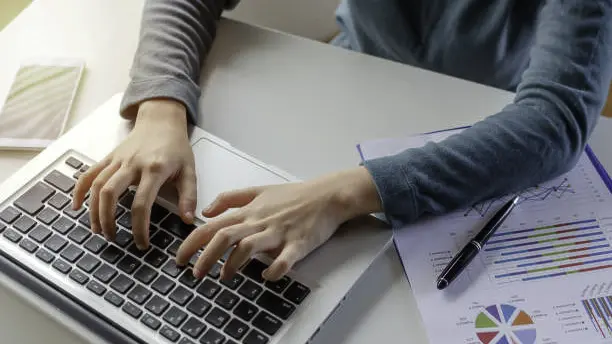 News Blog Image_Overhead Image Hands Typing on Laptop_iStockphoto-1165857932