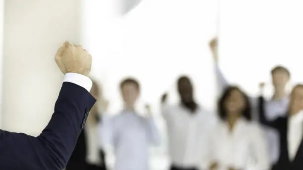 News Blog Image_Raised Fist in Office_iStockphoto-1158514109