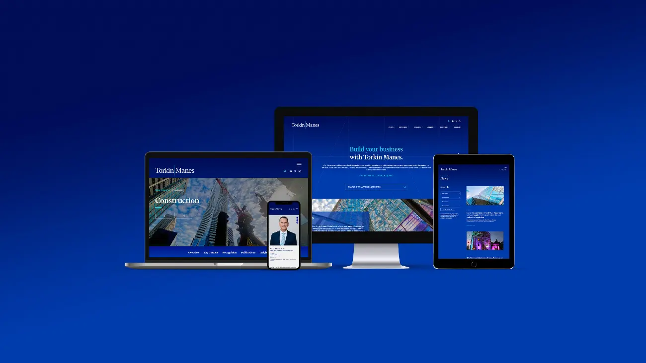 Laptop, mobile phone, desktop monitor, and tablet all open to Torkin Manes' website